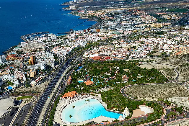 Aerial view of Siam Park among the hills of Costa Adeje with the sea and Playa de las Americas behind